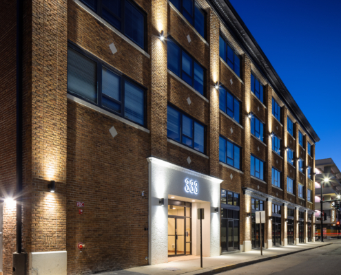 The outside of the arnold apartments from street view.